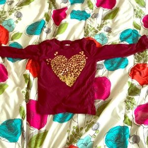 Red shirt with gold hearts making one big heart